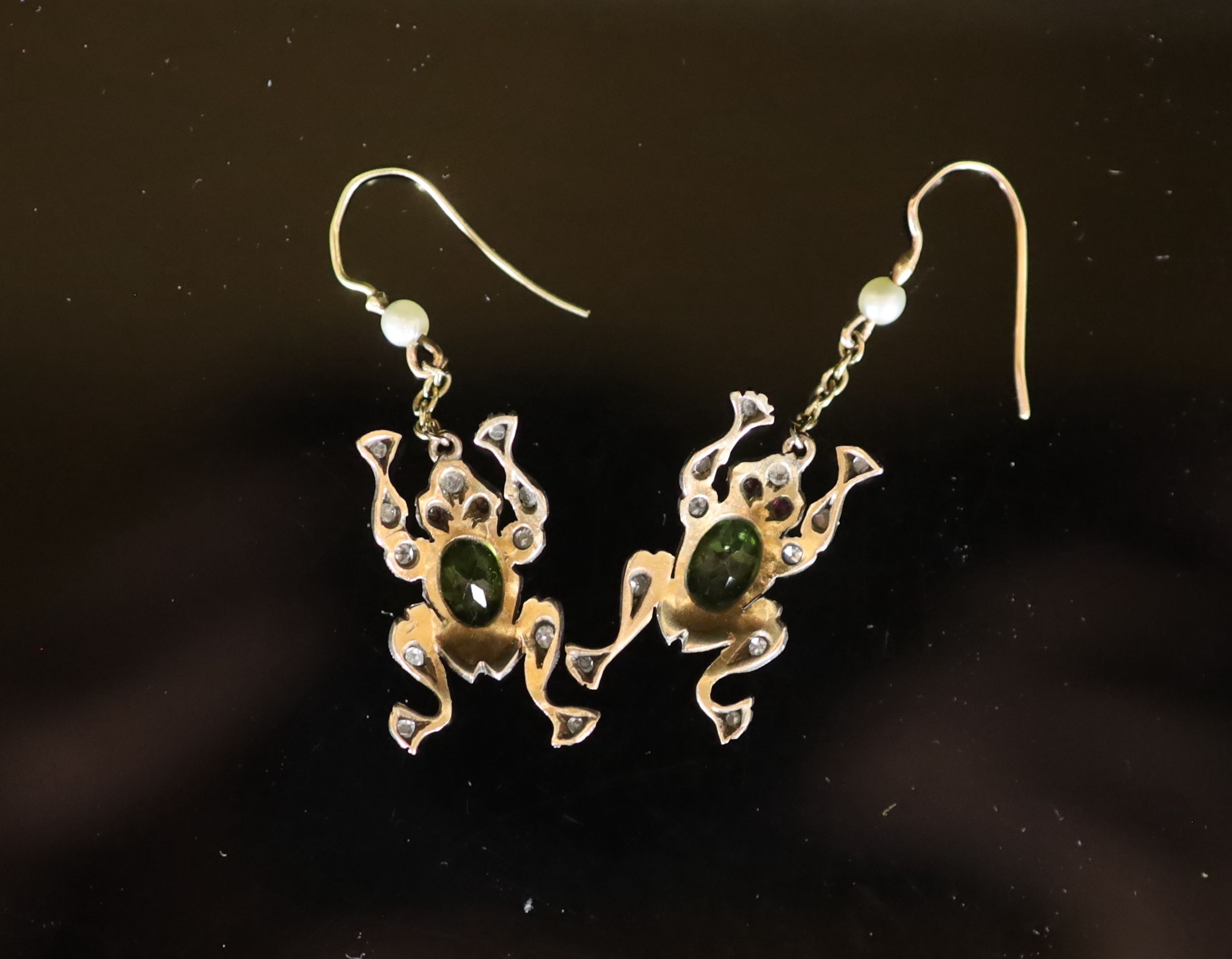 A pair of novelty early to mid 20th century gold, peridot, ruby, diamond and seed pearl set drop earrings, each modelled as a frog